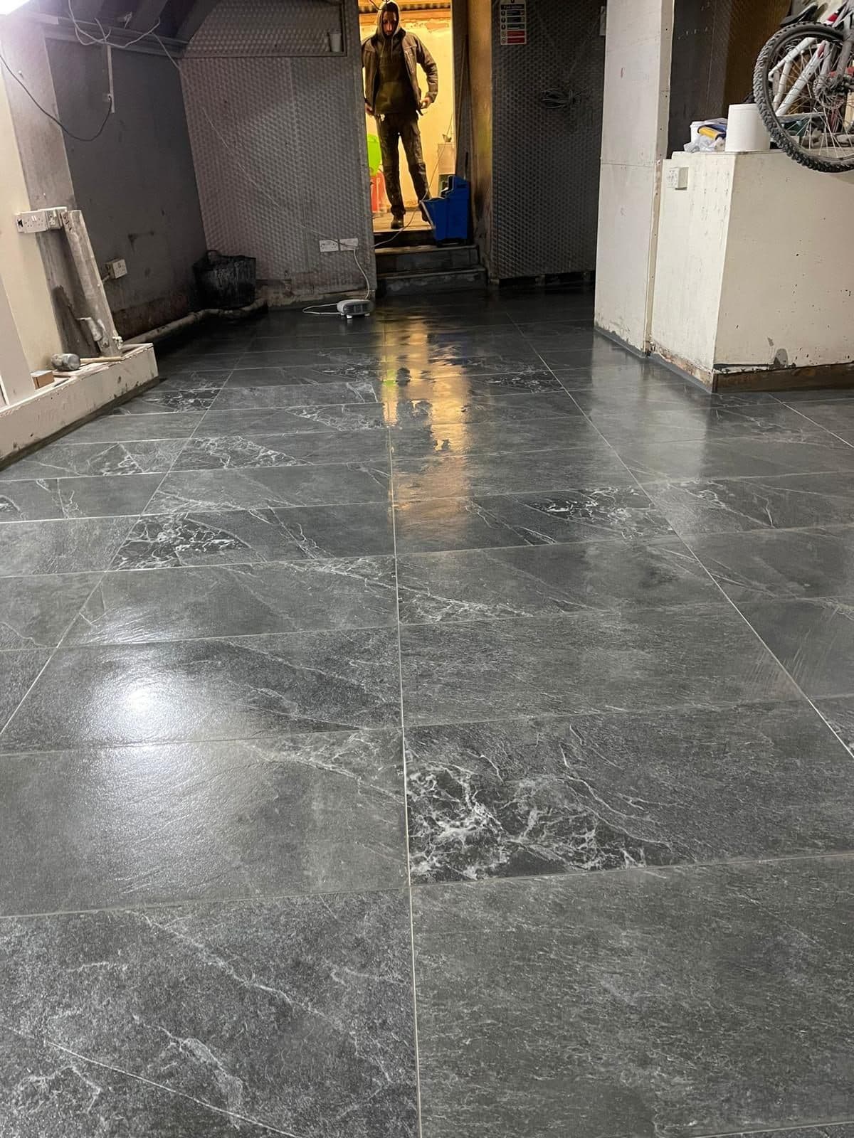 Finished marble-effect tiled floor in a UK home renovation — project example 2