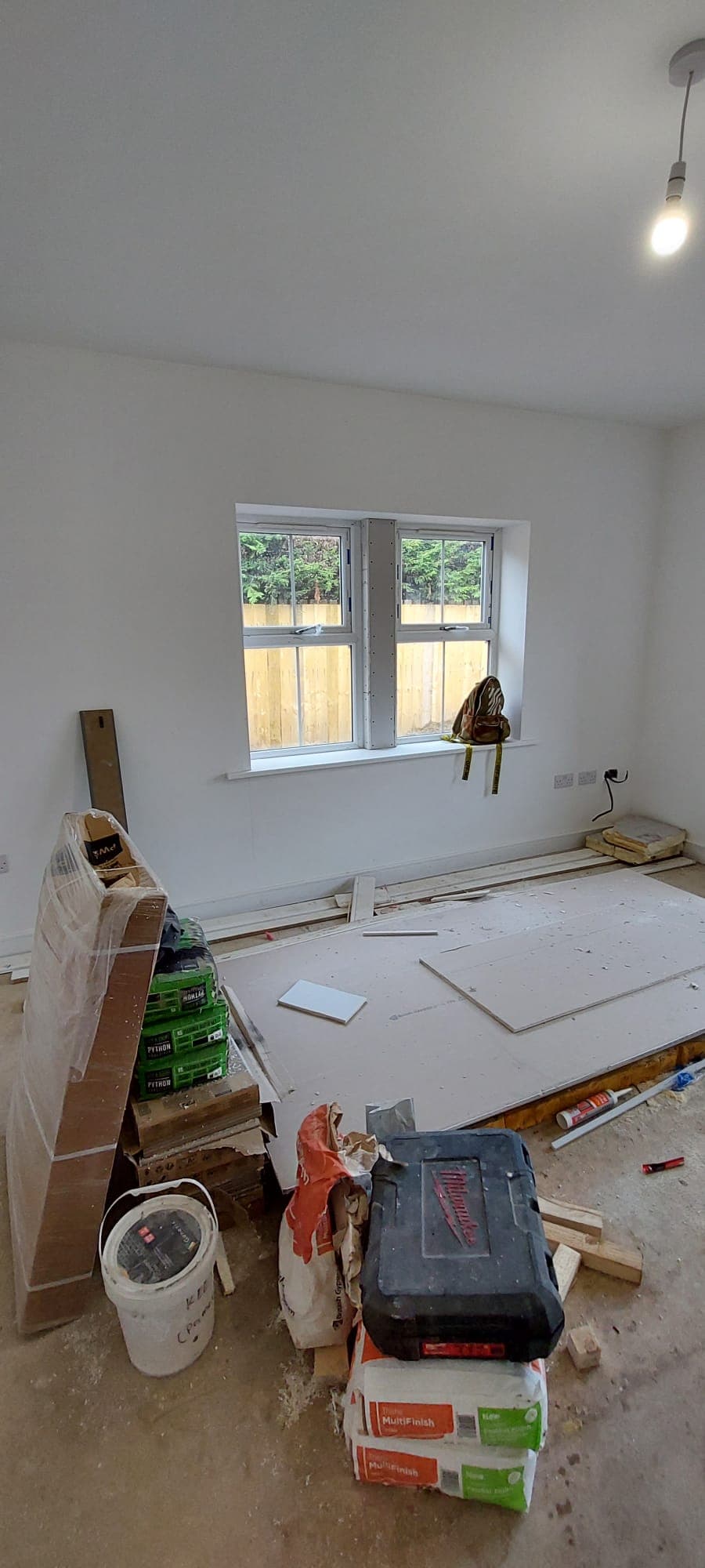 Plastering materials and tools set out during a general building project in a UK home