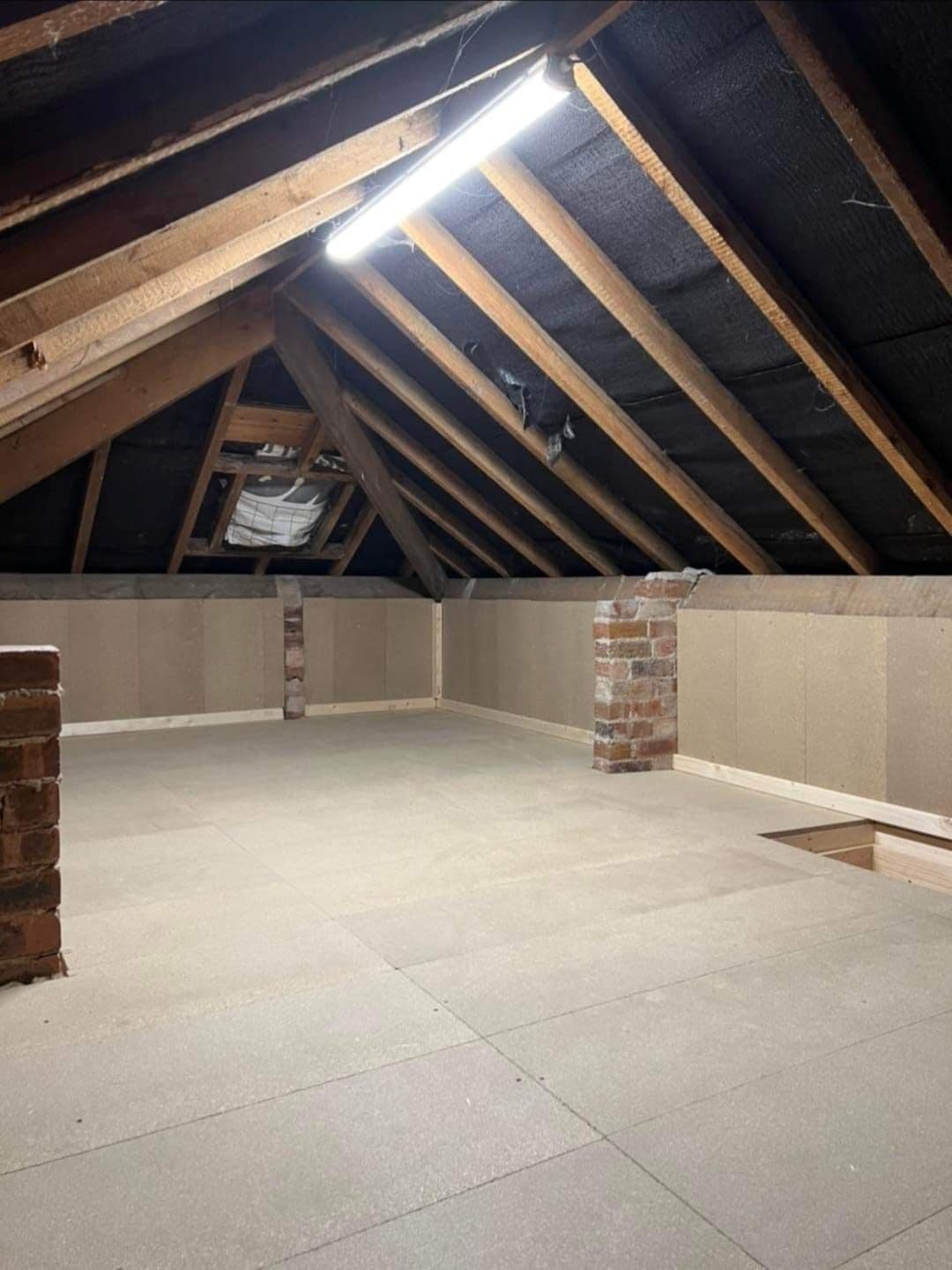 Finished loft conversion bedroom with roof windows in a UK home — project example 3
